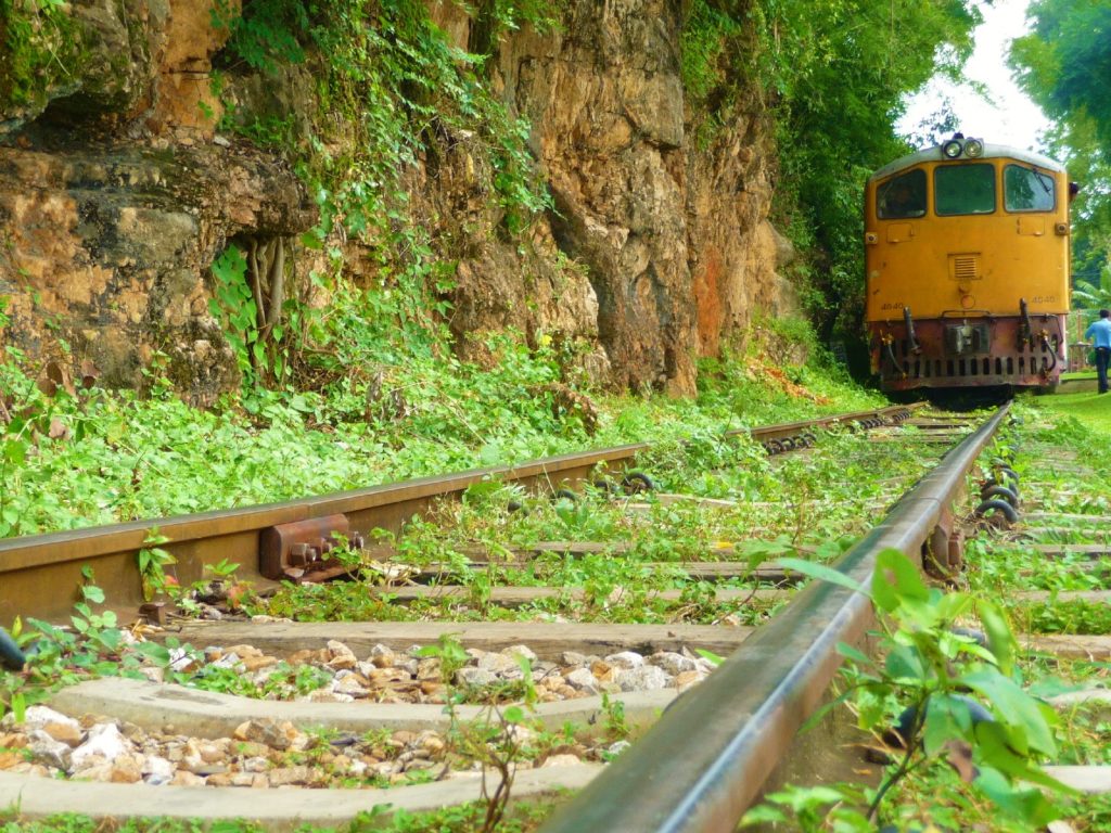 train qui arrive sur la ligne de chemin de fer sur un pont longeant les parois karstique près de Kra Sae Cave entre kanchanaburi et sai yok noi